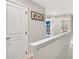 Upstairs hallway with an open doorway to a room with blue walls and a crib at 3374 Verdi Ln, Kennesaw, GA 30144