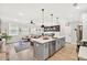 Open-concept kitchen and living room featuring a spacious island, modern appliances, and lots of natural light at 3374 Verdi Ln, Kennesaw, GA 30144