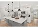 Contemporary kitchen with a gray island, white cabinetry, and modern pendant lighting at 3374 Verdi Ln, Kennesaw, GA 30144