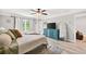 A spacious bedroom with a mounted TV, large mirror, and a glimpse into another room at 3374 Verdi Ln, Kennesaw, GA 30144