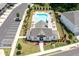 Aerial view of community pool with clubhouse surrounded by trees and parking at 3374 Verdi Ln, Kennesaw, GA 30144