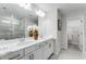 Spacious bathroom with double sinks, white cabinets, and glass shower at 5846 Schelton Se Pl, Mableton, GA 30126