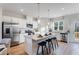 Well-lit kitchen boasts a central island with barstool seating and stainless steel appliances at 5846 Schelton Se Pl, Mableton, GA 30126