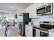 Bright kitchen featuring stainless steel appliances, granite countertops and white cabinets at 5846 Schelton Se Pl, Mableton, GA 30126
