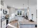 Modern kitchen with granite counters, white cabinets, stainless appliances, island and pendant lights at 5846 Schelton Se Pl, Mableton, GA 30126