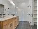 A bathroom featuring double sinks, granite countertops, a glass shower and a shelf at 150 Rolison Way, Fayetteville, GA 30214