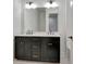 Bathroom featuring double sinks, quartz countertops and dark cabinets with gold hardware at 150 Rolison Way, Fayetteville, GA 30214
