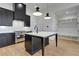 Modern kitchen with stainless steel appliances, an island with seating, and a pantry at 150 Rolison Way, Fayetteville, GA 30214