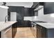 Modern kitchen features black cabinets, stainless steel appliances, white countertops, and hardwood floors at 150 Rolison Way, Fayetteville, GA 30214