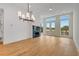 Bright living area with hardwood floors, a modern fireplace, stylish light fixture, and floor to ceiling windows at 150 Rolison Way, Fayetteville, GA 30214