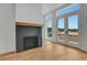 Bright living room featuring a modern fireplace and expansive windows, with beautiful hardwood floors at 150 Rolison Way, Fayetteville, GA 30214