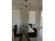 Dining room featuring a glass top table with modern black chairs and a contemporary light fixture for a stylish space at 162 Camden Woods Dr, Dallas, GA 30157