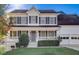 Charming two-story home featuring a well-manicured front yard, a welcoming porch, and an attached two-car garage at 162 Camden Woods Dr, Dallas, GA 30157