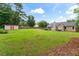 Huge backyard with grassy lawn, wood fence, outbuilding, and view of the home at 200 Pine Tree Ln, Mcdonough, GA 30252