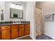 Bathroom features a vanity with warm wood tones and a shower with a floral curtain at 200 Pine Tree Ln, Mcdonough, GA 30252