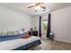 Bedroom with blue bedspread, workspace desk, and sun-filled window with curtains at 200 Pine Tree Ln, Mcdonough, GA 30252