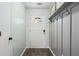 Welcoming foyer with wood-look floors, white door, paneled wall and convenient coat hooks at 200 Pine Tree Ln, Mcdonough, GA 30252