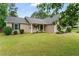 Charming single-story home featuring a manicured lawn and inviting front porch with rocking chairs at 200 Pine Tree Ln, Mcdonough, GA 30252