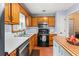 Functional kitchen features wood cabinets, stainless steel appliances, and a butcher block island at 200 Pine Tree Ln, Mcdonough, GA 30252