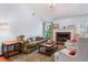 Cozy living room featuring a fireplace, vaulted ceiling, and comfortable seating arrangement at 200 Pine Tree Ln, Mcdonough, GA 30252