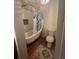 Bathroom featuring a claw foot tub with gold fixtures and a decorative shower curtain, complemented by stylish tile accents at 2500 Trent Dr, Marietta, GA 30066