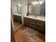 Modern bathroom featuring granite counters, a large mirror, and warm wood accents at 2500 Trent Dr, Marietta, GA 30066