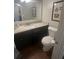 Bathroom with granite counters, dark wood cabinets, modern faucet and a white toilet at 2500 Trent Dr, Marietta, GA 30066