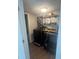 Laundry room with a front-load washer and dryer, open shelving and hardwood-style floors at 2500 Trent Dr, Marietta, GA 30066