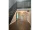 Open-concept living room with hardwood floors, dark staircase, and a view of the second-story railing at 2500 Trent Dr, Marietta, GA 30066