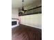Spacious living room with dark hardwood floors, a white painted brick fireplace and vaulted ceiling with fan at 2500 Trent Dr, Marietta, GA 30066