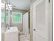 Bright bathroom featuring a white vanity, shower and tub combination, and a storage closet at 5510 Stoneybrook Se Ct, Mableton, GA 30126