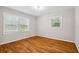 Empty room features hardwood floors, neutral walls, and two windows at 5510 Stoneybrook Se Ct, Mableton, GA 30126