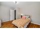 Cozy bedroom with hardwood floors, a patterned quilt, and a bright window view at 5510 Stoneybrook Se Ct, Mableton, GA 30126