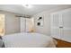 Bedroom featuring hardwood floors, patterned bedspread, barn door, and closet doors at 5510 Stoneybrook Se Ct, Mableton, GA 30126