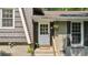 Close up of the front door and brick exterior of this charming home with windowed door and hanging plant at 5510 Stoneybrook Se Ct, Mableton, GA 30126