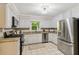 A well-lit kitchen featuring modern stainless steel appliances, granite counters, and white cabinets at 5510 Stoneybrook Se Ct, Mableton, GA 30126