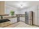 Updated kitchen with stainless steel appliances, granite countertops, and ample white cabinet space at 5510 Stoneybrook Se Ct, Mableton, GA 30126