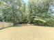 Large backyard showcasing newly spread straw and a newly stained fence at 2335 Huntington Dr, Loganville, GA 30052