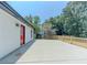 Home featuring a spacious concrete patio and freshly stained fence and red door at 2335 Huntington Dr, Loganville, GA 30052