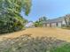 Large yard with newly spread straw and a freshly stained fence surrounding property at 2335 Huntington Dr, Loganville, GA 30052