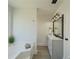 Bright bathroom featuring tub, vanity with framed mirror, modern lights and plank flooring at 2335 Huntington Dr, Loganville, GA 30052