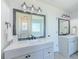 Bathroom featuring double vanity, framed mirrors, and modern lighting fixtures at 2335 Huntington Dr, Loganville, GA 30052