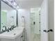 Bright bathroom with modern vanity, matte black fixtures, and decorative mirror at 2335 Huntington Dr, Loganville, GA 30052