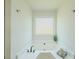 Bright bathroom featuring a soaking tub with a window, providing a relaxing and naturally lit space at 2335 Huntington Dr, Loganville, GA 30052