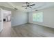 Bedroom featuring a tray ceiling, ceiling fan, accent wall, and access to kitchen at 2335 Huntington Dr, Loganville, GA 30052