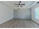 A bright bedroom featuring a tray ceiling, ceiling fan, view to the outside at 2335 Huntington Dr, Loganville, GA 30052