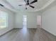 A bright bedroom featuring a tray ceiling, ceiling fan, walk-in closet, and access to ensuite bathroom at 2335 Huntington Dr, Loganville, GA 30052