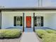 Inviting front porch with a vibrant red door, black shutters, and manicured landscaping, providing great curb appeal at 2335 Huntington Dr, Loganville, GA 30052