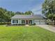 Charming single-story home featuring a red front door, well-manicured lawn, and attached two-car garage at 2335 Huntington Dr, Loganville, GA 30052