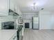 Well-lit kitchen with stainless steel refrigerator, white cabinets, and stylish lighting at 2335 Huntington Dr, Loganville, GA 30052